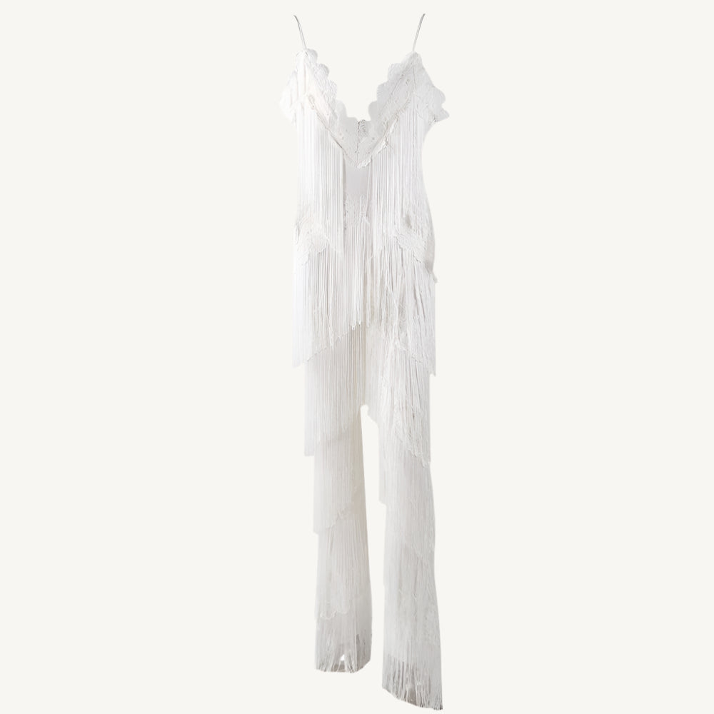 A chic white tassel jumpsuit with a flattering fit, featuring tassel details along the neckline and sleeves for a touch of playful elegance. The jumpsuit is perfect for both casual and semi-formal occasions, providing comfort without sacrificing style.