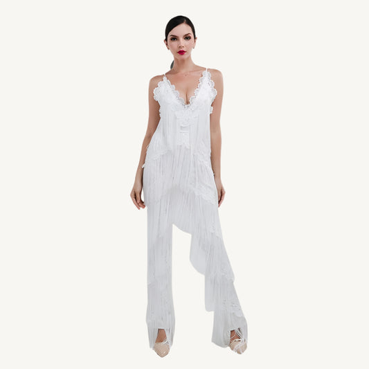 A chic white tassel jumpsuit with a flattering fit, featuring tassel details along the neckline and sleeves for a touch of playful elegance. The jumpsuit is perfect for both casual and semi-formal occasions, providing comfort without sacrificing style.